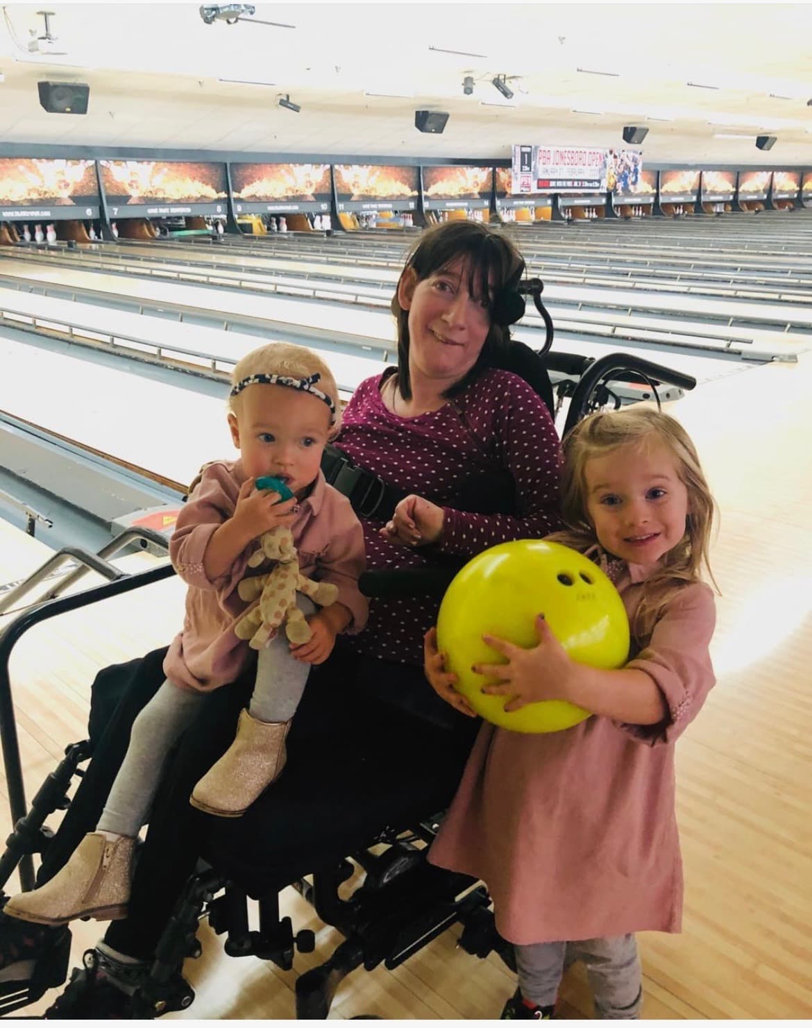Elizabeth at a bowling alley with two young girls